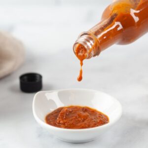Hot Sauce Pouring Into a Bowl